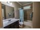 Cozy bathroom with shower-tub combo and vanity with sink at 6248 Sunshine Cove Ln, Buford, GA 30518