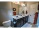 Spacious bathroom features double sinks, dark cabinets, tile floors and fluffy white rug at 6248 Sunshine Cove Ln, Buford, GA 30518