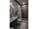Bathroom featuring shower with decorative curtain, round mirror, and decorative artwork at 6248 Sunshine Cove Ln, Buford, GA 30518