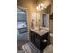 Bathroom with dark vanity, decorative mirror and towels with an adjoining bedroom at 6248 Sunshine Cove Ln, Buford, GA 30518