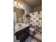 Bathroom with dark vanity, decorative mirror and shower at 6248 Sunshine Cove Ln, Buford, GA 30518