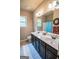 Bright bathroom with double sinks, a large mirror, and a blue patterned shower curtain at 6248 Sunshine Cove Ln, Buford, GA 30518