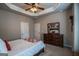 Comfortable bedroom with a dresser and mirror, complemented by crown molding, a ceiling fan, and recessed lighting at 6248 Sunshine Cove Ln, Buford, GA 30518