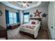 Charming bedroom featuring a comfortable bed with patriotic decor and natural light from the window at 6248 Sunshine Cove Ln, Buford, GA 30518