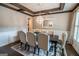 Traditional dining room featuring wainscoting, a coffered ceiling, and elegant upholstered chairs at 6248 Sunshine Cove Ln, Buford, GA 30518