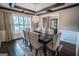 Dining room with coffered ceiling, stylish chairs, plantation shutters and an elegant chandelier at 6248 Sunshine Cove Ln, Buford, GA 30518