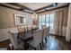 Dining area with designer chandelier, decorative mirror, and stylish seating with shuttered windows at 6248 Sunshine Cove Ln, Buford, GA 30518