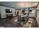 Elegant dining room featuring stylish lighting, a bar area, and seating for eight at 6248 Sunshine Cove Ln, Buford, GA 30518