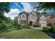 Charming two-story home with a manicured lawn and elegant brick and stone architecture at 6248 Sunshine Cove Ln, Buford, GA 30518