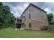 Back exterior view of home featuring a patio, screened porch, and brick accents at 6248 Sunshine Cove Ln, Buford, GA 30518