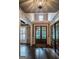 Elegant foyer featuring dark wood floors, a modern chandelier, and a clear view to the front yard at 6248 Sunshine Cove Ln, Buford, GA 30518