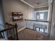 Hallway overlooking the foyer features a chandelier, a bookshelf and the home's front door at 6248 Sunshine Cove Ln, Buford, GA 30518