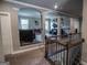 Upstairs landing overlooking a lounge area with views to the outdoors at 6248 Sunshine Cove Ln, Buford, GA 30518