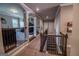 Hallway with decorative railing, arched columns, and access to multiple rooms at 6248 Sunshine Cove Ln, Buford, GA 30518