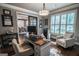 Bright home office with modern décor, stylish seating, shutters, and glass paneled doors at 6248 Sunshine Cove Ln, Buford, GA 30518