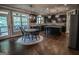 Gourmet kitchen with dark cabinets, granite countertops, and stainless-steel appliances at 6248 Sunshine Cove Ln, Buford, GA 30518