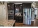 A bright kitchen featuring stainless steel appliances and sleek dark wood cabinetry with granite counters at 6248 Sunshine Cove Ln, Buford, GA 30518