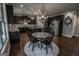 Gourmet kitchen with dark cabinets, granite countertops, and stainless-steel appliances at 6248 Sunshine Cove Ln, Buford, GA 30518