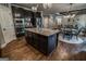 Open-concept kitchen boasts a center island, stainless appliances, and connects seamlessly to dining, and living areas at 6248 Sunshine Cove Ln, Buford, GA 30518