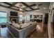 Spacious living room featuring a fireplace, coffered ceiling and hardwood floors at 6248 Sunshine Cove Ln, Buford, GA 30518