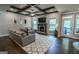 Bright living room with fireplace, large windows, and comfortable seating area at 6248 Sunshine Cove Ln, Buford, GA 30518