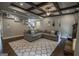 Inviting living room with coffered ceiling, plush sofa, and large patterned rug at 6248 Sunshine Cove Ln, Buford, GA 30518