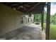 Covered patio with ceiling fans overlooking fire pit and spacious backyard at 6248 Sunshine Cove Ln, Buford, GA 30518
