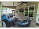 Enjoy this inviting screened porch with comfortable wicker furniture, ceiling fans, and outdoor views at 6248 Sunshine Cove Ln, Buford, GA 30518