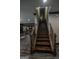 Elegant staircase with dark wood steps and decorative iron railings at 6248 Sunshine Cove Ln, Buford, GA 30518