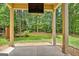 A covered back patio offers a serene view of the lush backyard at 50 Star Spangled Ln, Peachtree City, GA 30269