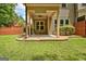 Covered back porch with ceiling fan, and view of the landscaped backyard at 50 Star Spangled Ln, Peachtree City, GA 30269