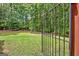 View of fenced backyard featuring healthy, green lawn and mature shade trees at 50 Star Spangled Ln, Peachtree City, GA 30269