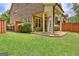 Manicured backyard with a well-maintained lawn and covered patio at 50 Star Spangled Ln, Peachtree City, GA 30269