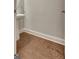 This half bathroom features a pedestal sink and brown wood flooring at 50 Star Spangled Ln, Peachtree City, GA 30269