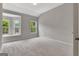 Bright bedroom with neutral carpet, two windows, and light gray walls at 50 Star Spangled Ln, Peachtree City, GA 30269
