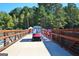 View of the bridge with a golf cart and trees in the background at 50 Star Spangled Ln, Peachtree City, GA 30269