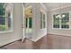 Inviting dining area featuring hardwood floors, bright windows, and access to patio at 50 Star Spangled Ln, Peachtree City, GA 30269