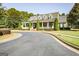 Elegant exterior view with a welcoming front porch, dormer windows, and lush greenery at 50 Star Spangled Ln, Peachtree City, GA 30269