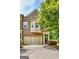 Inviting brick townhome featuring a two-car garage, bay window and covered front porch amidst lush landscaping at 50 Star Spangled Ln, Peachtree City, GA 30269