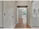 Hallway view showcasing open doorways, wood flooring, and access to various rooms in the home at 50 Star Spangled Ln, Peachtree City, GA 30269