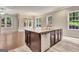 Kitchen island with granite countertops, stainless steel dishwasher, and dark cabinetry, open to the bright and airy living space at 50 Star Spangled Ln, Peachtree City, GA 30269