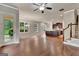 Open-concept living room with hardwood floors and seamless flow to kitchen at 50 Star Spangled Ln, Peachtree City, GA 30269