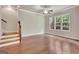 Spacious living room with hardwood floors, natural light, and a ceiling fan at 50 Star Spangled Ln, Peachtree City, GA 30269