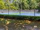 Community tennis courts surrounded by mature trees and a privacy fence at 50 Star Spangled Ln, Peachtree City, GA 30269