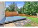 A blue backyard deck is surrounded by a wooded yard with a wooden privacy fence at 147 Calico Loop, Grantville, GA 30220