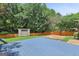 The blue backyard deck is surrounded by a wooden privacy fence and a wooded yard at 147 Calico Loop, Grantville, GA 30220