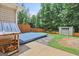 View of the blue backyard deck with shed surrounded by a wooded fence-lined yard at 147 Calico Loop, Grantville, GA 30220