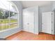 Bright bedroom featuring multiple closets and a large window at 147 Calico Loop, Grantville, GA 30220