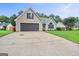 Inviting single-Gathering home with a long driveway leading to an attached garage at 147 Calico Loop, Grantville, GA 30220