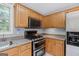 Close-up of stainless appliances, including gas cooktop and double oven, in a well-appointed kitchen at 147 Calico Loop, Grantville, GA 30220